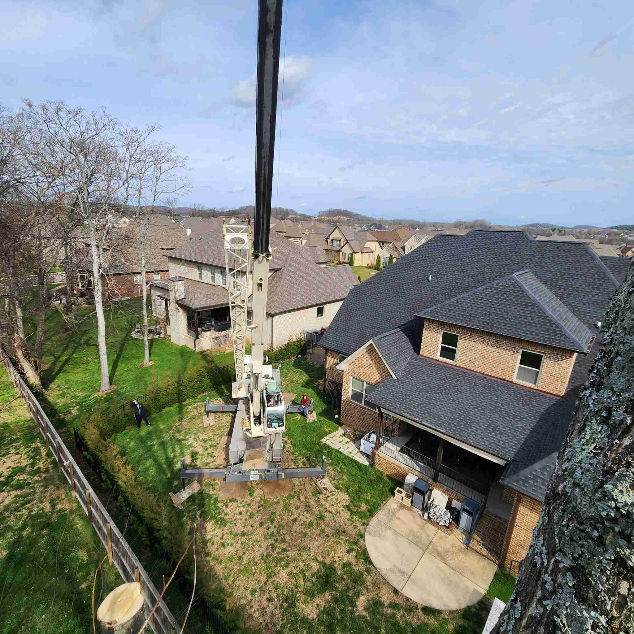 Aerial view of crane over neighborhood